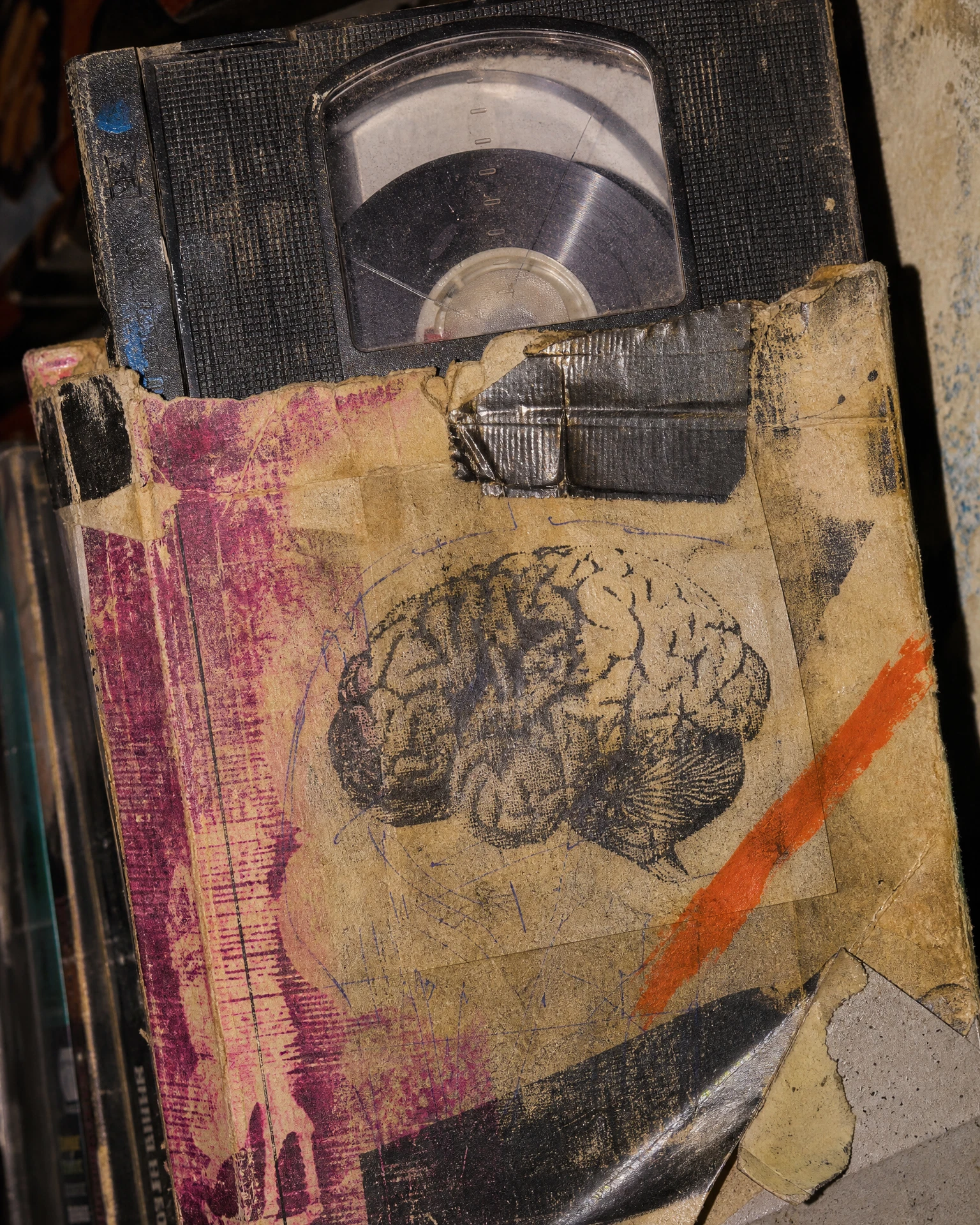 Distressed VHS tape in a torn rental sleeve